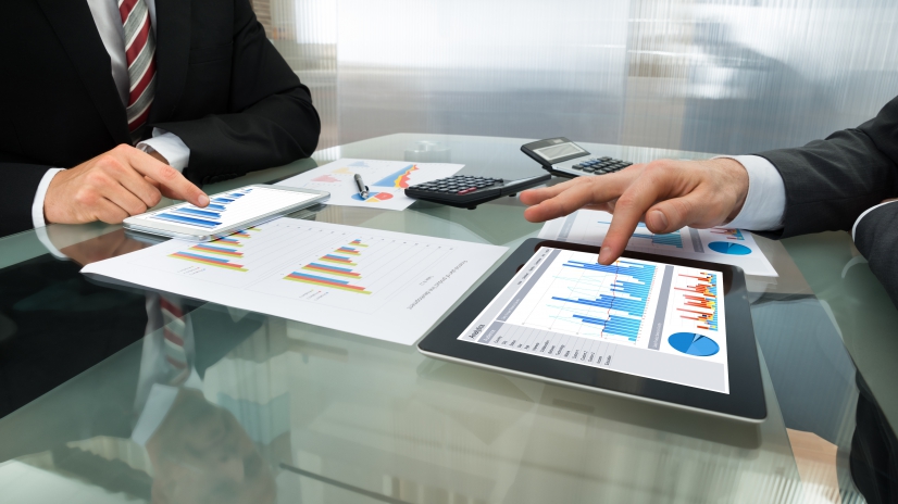 Close-up Of Two Businessman Analyzing Graph On Digital Tablet